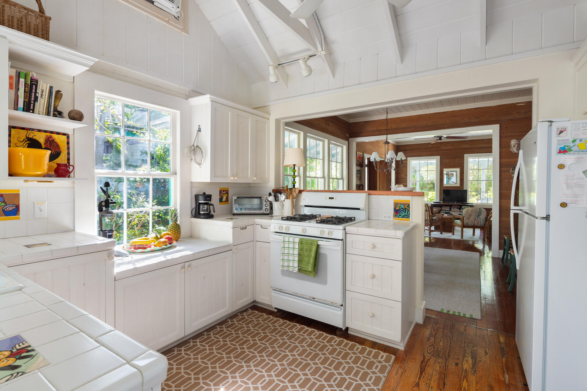 623 Catholic Lane Key West, FL 33040 - Photo 12 of 29 a kitchen with a white cabinets and wooden floor