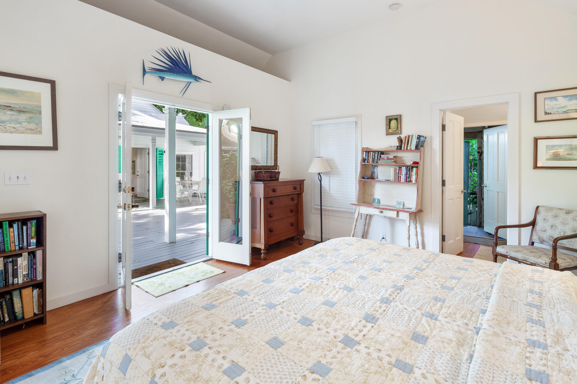 623 Catholic Lane Key West, FL 33040 - Photo 23 of 29 a bedroom with a large bed and a book shelf