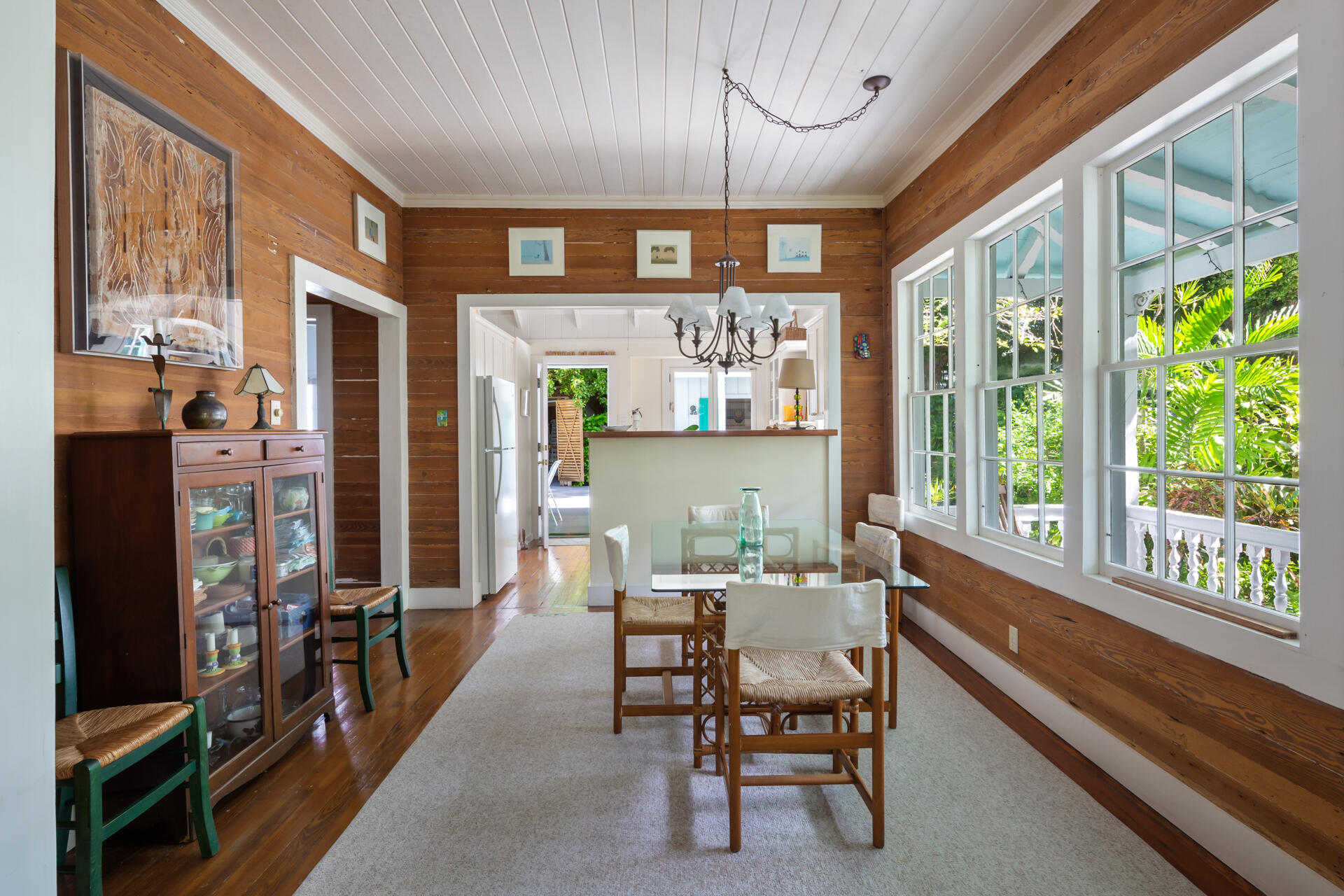 623 Catholic Lane Key West, FL 33040 - Photo 10 of 29 a dining room with wooden floor a chandelier a wooden table and chairs