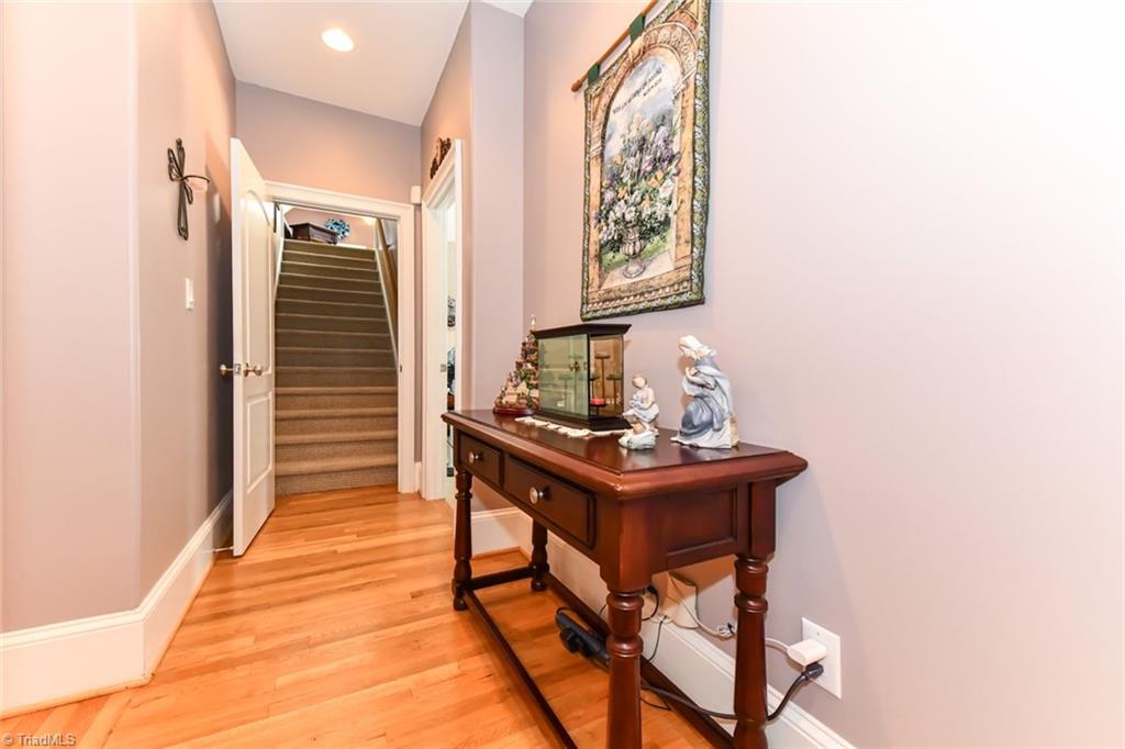 6021 Beckenham Way Oak Ridge, NC 27310 - Photo 11 of 44 Dining room on hardwood floors with a double tray ceiling and chair rail with a large palladium picture window.