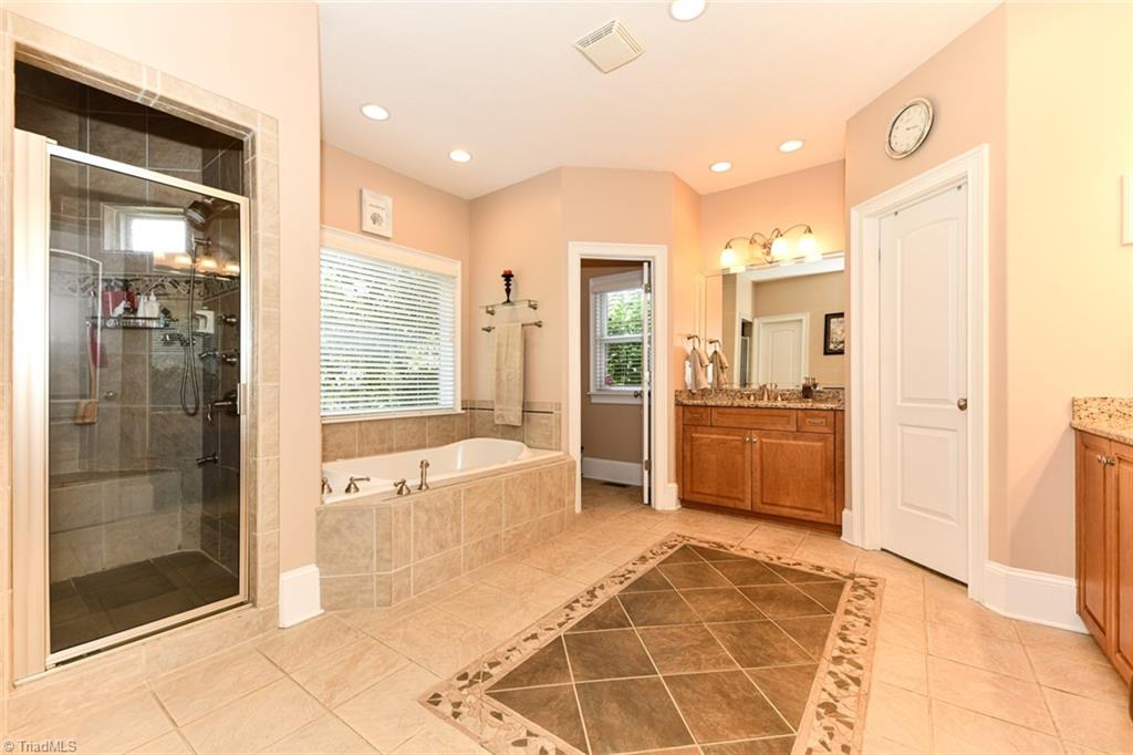 6021 Beckenham Way Oak Ridge, NC 27310 - Photo 14 of 44 Kitchen has a convenient Kitchen island and pantry with a built in wine rack.