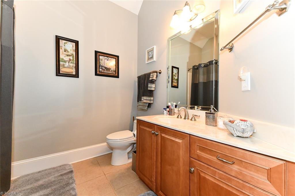 6021 Beckenham Way Oak Ridge, NC 27310 - Photo 20 of 44 Master boasts a triple tray ceiling and lovely sitting area and has access to the outside patio.