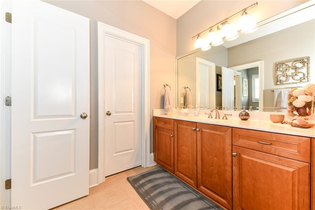 6021 Beckenham Way Oak Ridge, NC 27310 - Photo 21 of 44 Custom Master Bath with separate tub and shower, dual vanity AREAS AND walk in closets all on custom tiling!
