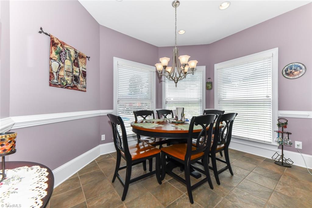 6021 Beckenham Way Oak Ridge, NC 27310 - Photo 10 of 44 Keeping Room off from the eat in kitchen with outside access.