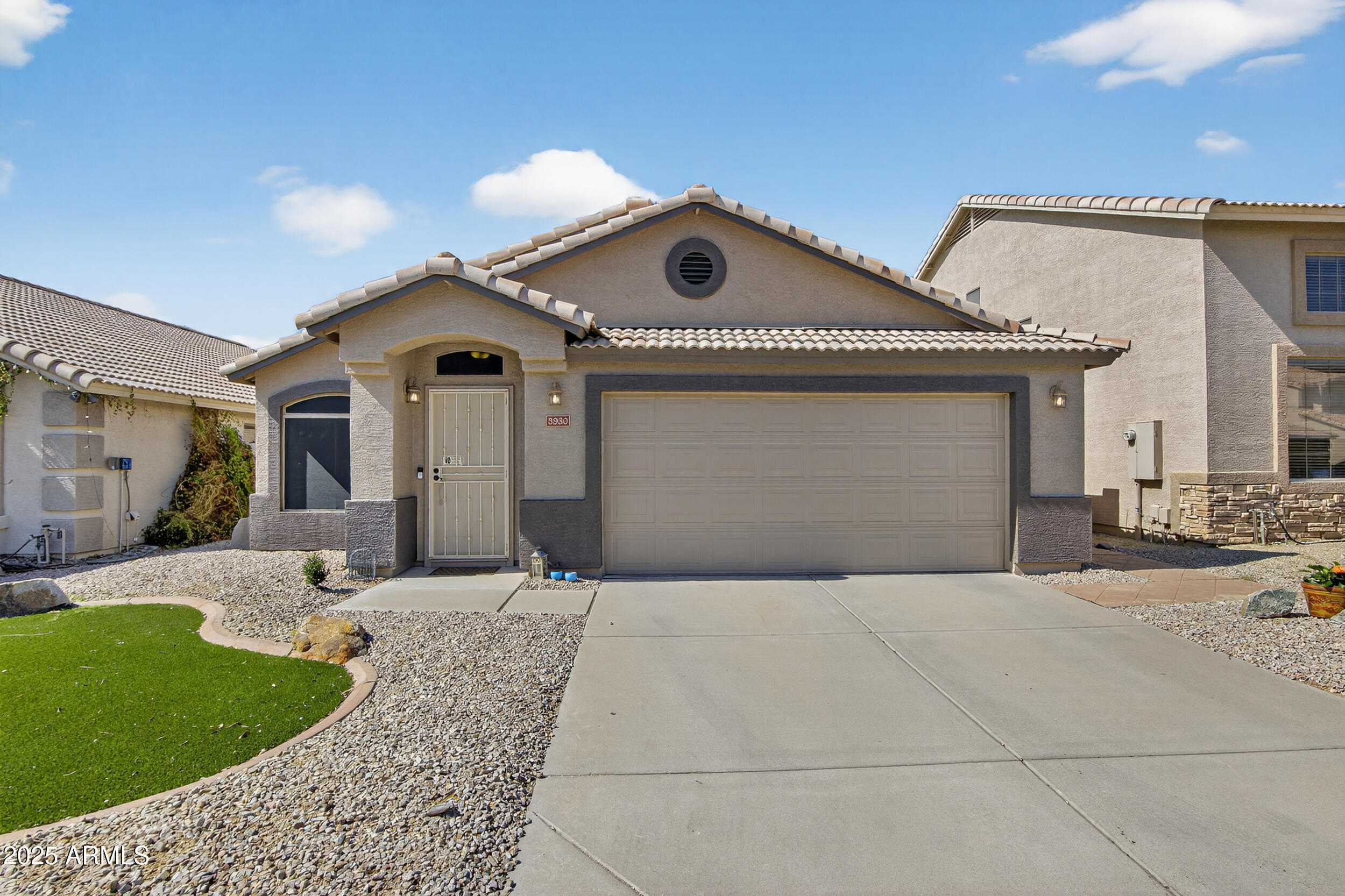 3930 East Agave Road Phoenix, AZ 85044 - Photo 2 of 44 a front view of a house with a yard and garage