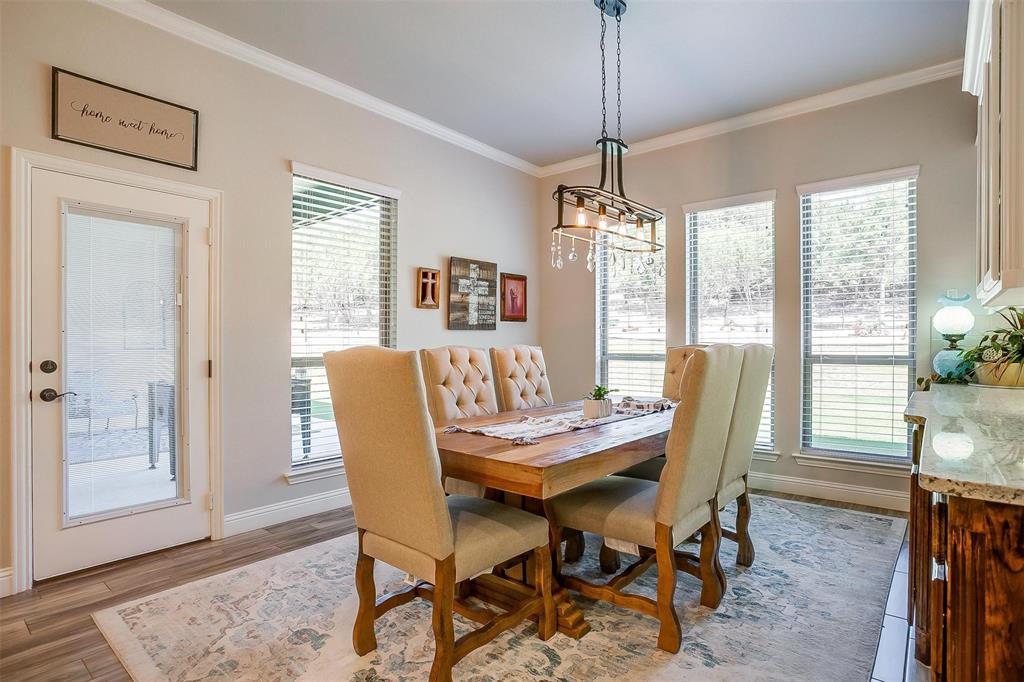 409 Glade Crest Road Azle, TX 76020 - Photo 12 of 31 a dining room with furniture window wooden floor