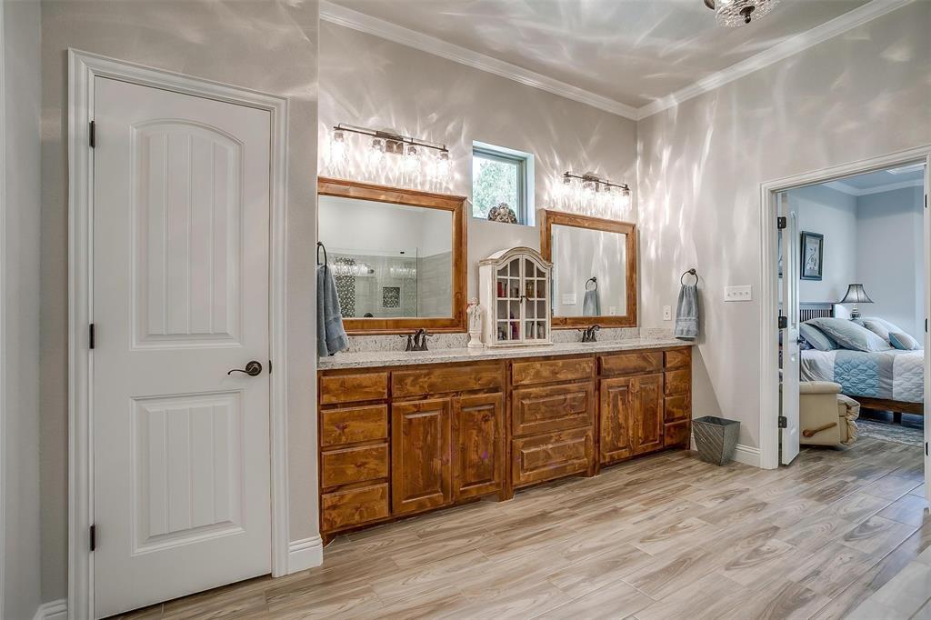 409 Glade Crest Road Azle, TX 76020 - Photo 14 of 31 a spacious bathroom with a double vanity sink and a mirror