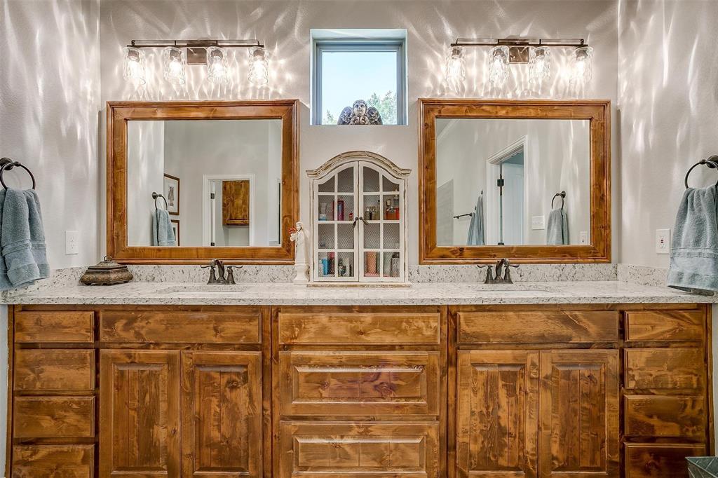 409 Glade Crest Road Azle, TX 76020 - Photo 17 of 31 a bathroom with double vanity sinks and a mirror