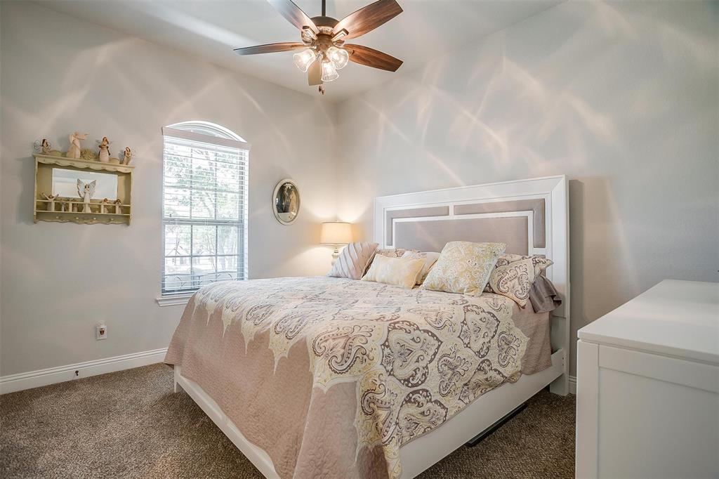 409 Glade Crest Road Azle, TX 76020 - Photo 20 of 31 a bedroom with a large bed and a window