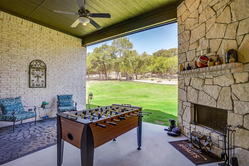409 Glade Crest Road Azle, TX 76020 - Photo 28 of 31 a living room with a fireplace and a flat screen tv