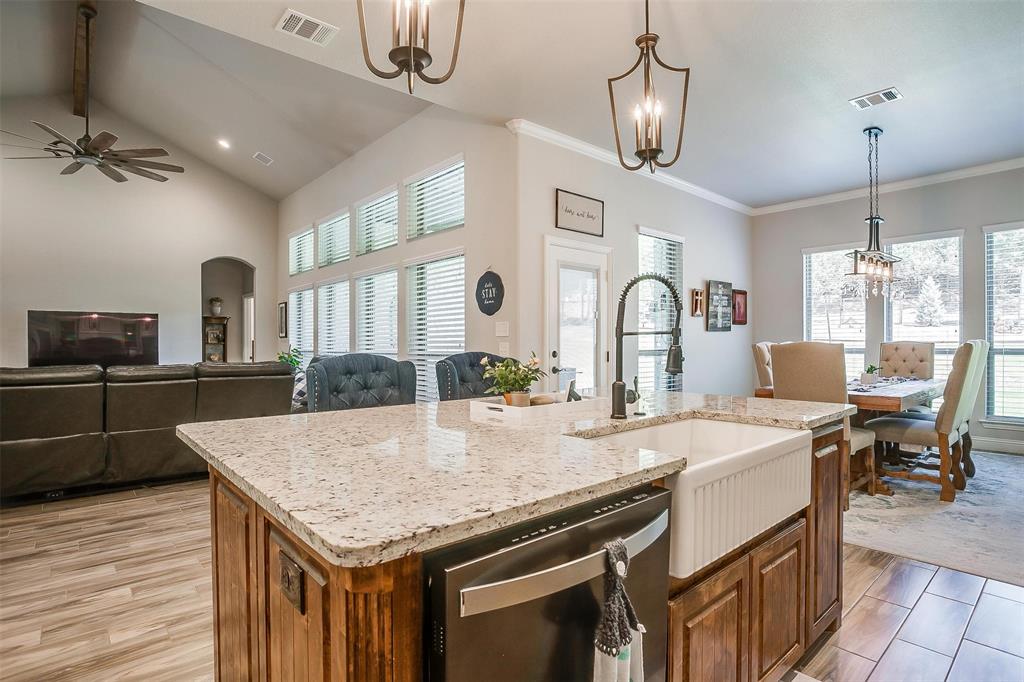 409 Glade Crest Road Azle, TX 76020 - Photo 5 of 31 a kitchen with center island table and chairs