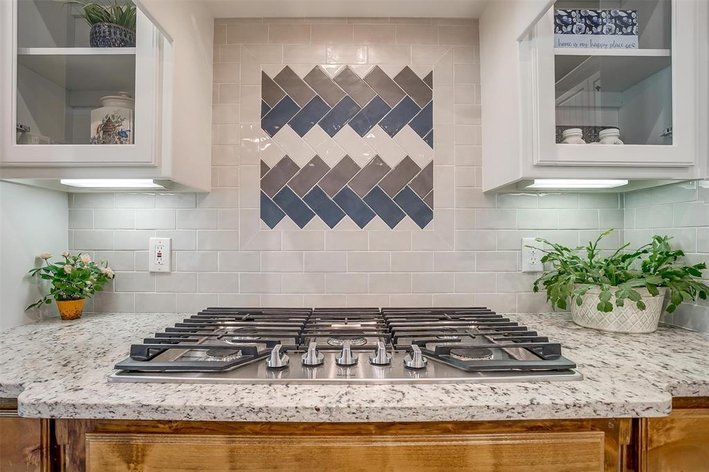 409 Glade Crest Road Azle, TX 76020 - Photo 9 of 31 a kitchen with a stove and a white cabinets