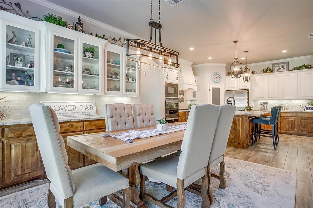 409 Glade Crest Road Azle, TX 76020 - Photo 10 of 31 a view of a dining room with furniture window and wooden floor