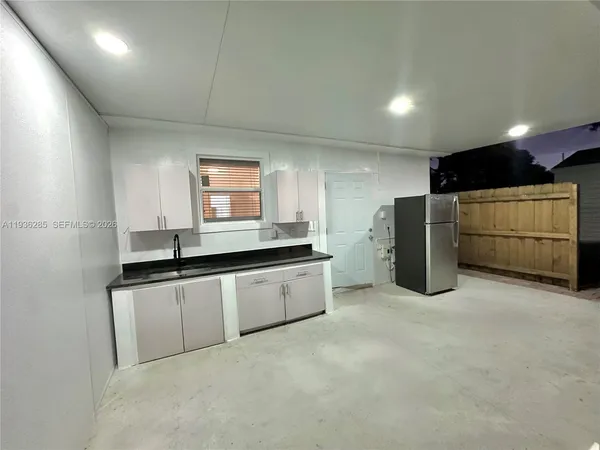 a kitchen with refrigerator and microwave