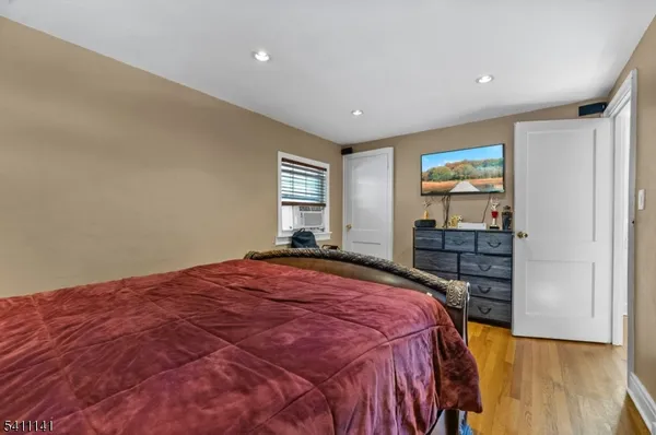 a bed sitting in a spacious bedroom next to a window