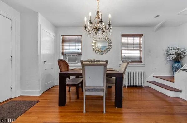 a view of a dining room with furniture windows and wooden floor