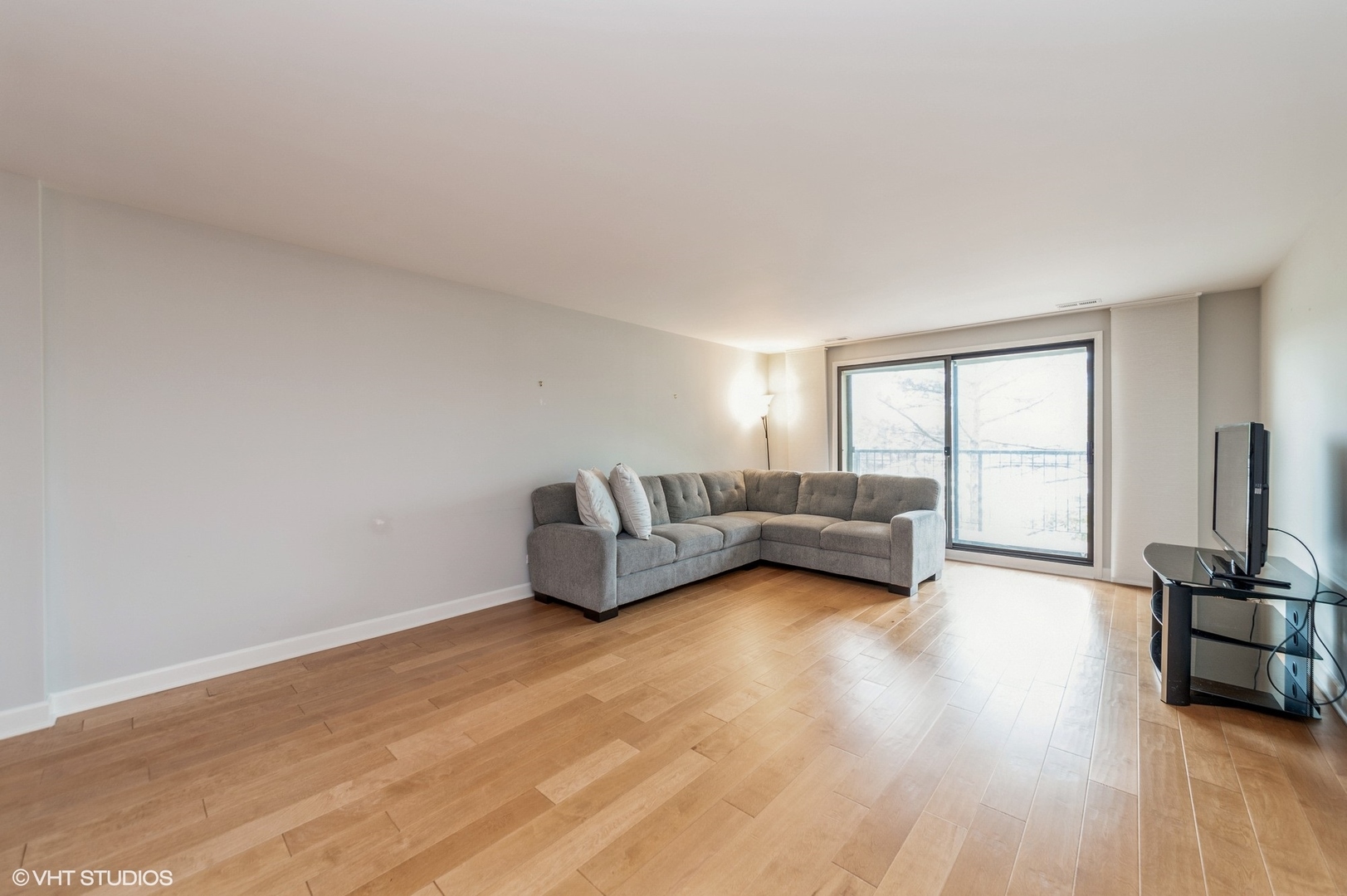 8610 Waukegan Road, Unit 306 Morton Grove, IL 60053 - Photo 2 of 13 a living room with furniture and a large window