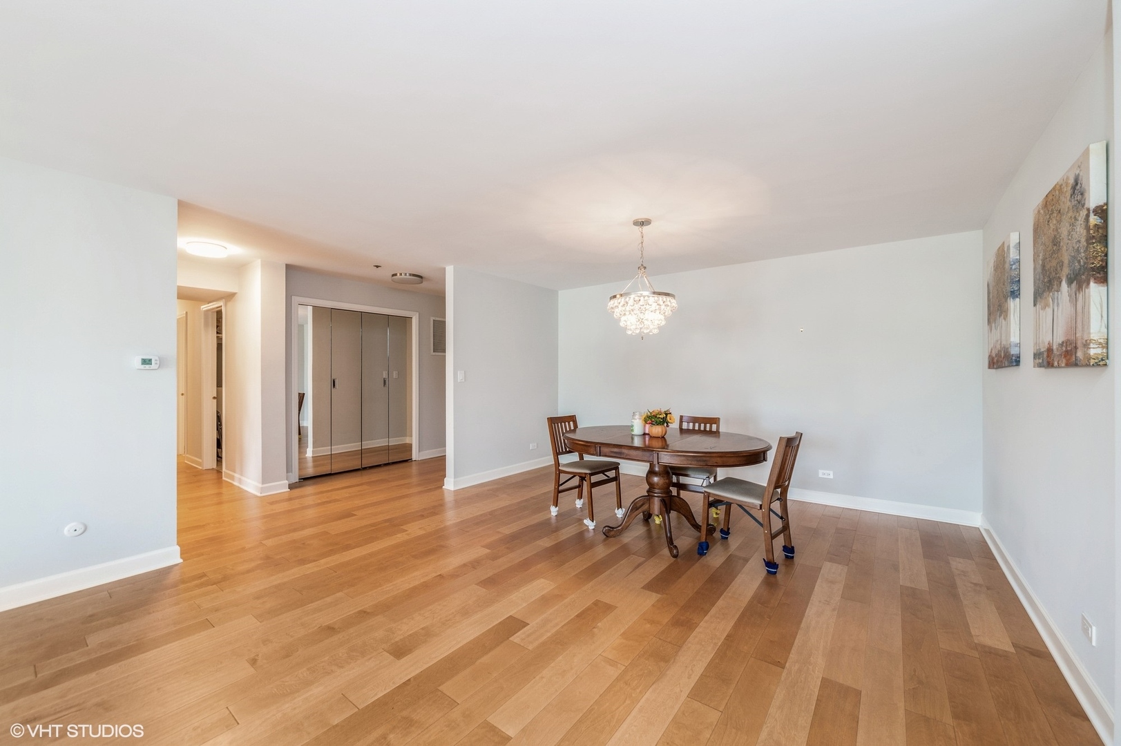 8610 Waukegan Road, Unit 306 Morton Grove, IL 60053 - Photo 3 of 13 an open kitchen with dining table and chairs