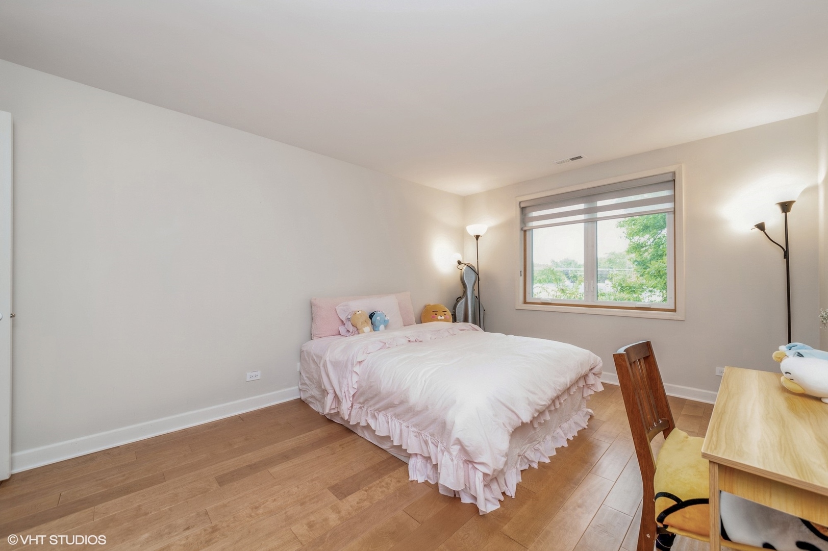 8610 Waukegan Road, Unit 306 Morton Grove, IL 60053 - Photo 6 of 13 a bedroom with a bed and a window