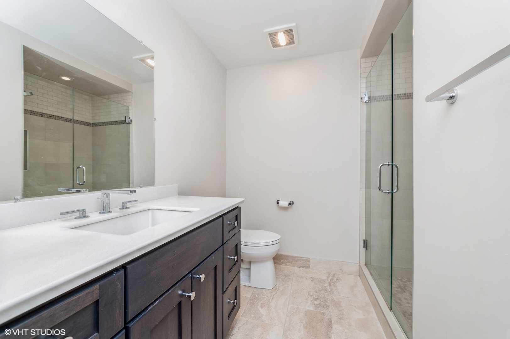 8610 Waukegan Road, Unit 306 Morton Grove, IL 60053 - Photo 7 of 13 a bathroom with a sink a toilet a shower and a mirror
