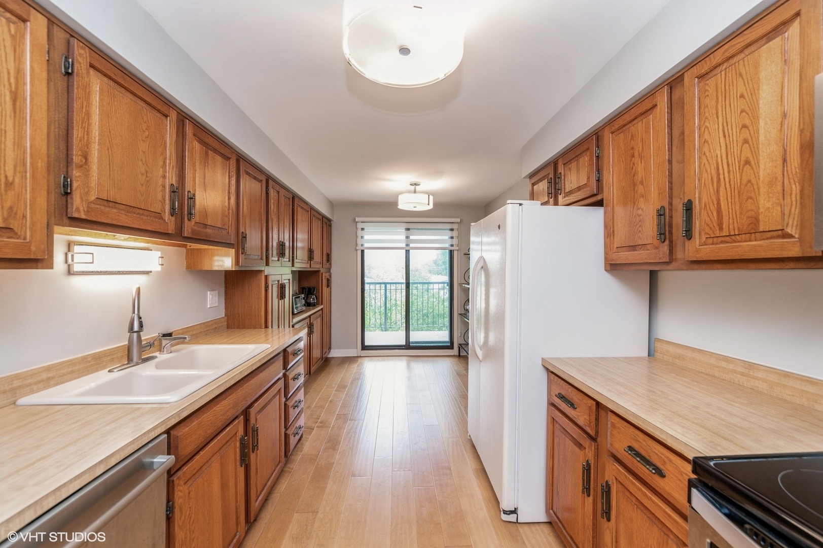 8610 Waukegan Road, Unit 306 Morton Grove, IL 60053 - Photo 8 of 13 a kitchen with stainless steel appliances granite countertop a sink stove and refrigerator