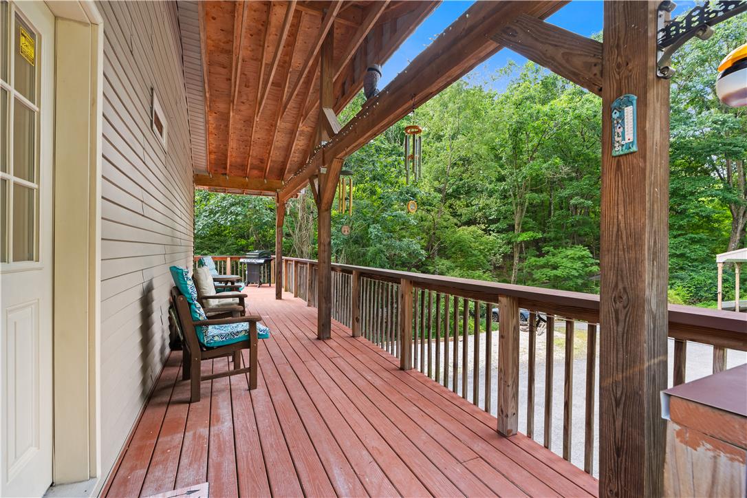 7353 Farrier Road Orefield, PA 18069 - Photo 12 of 74 An expansive covered wooden deck looks out over peaceful surrounding woodlands.