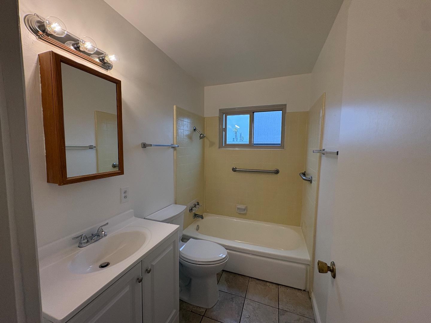 1675 Luxton Street Seaside, CA 93955 - Photo 19 of 33 a bathroom with a toilet a sink a tub and mirror