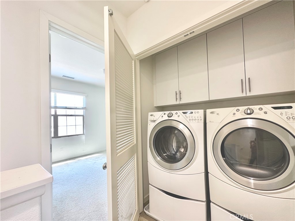 129 Briarberry Irvine, CA 92618 - Photo 16 of 26 a view of a hallway with washer and dryer