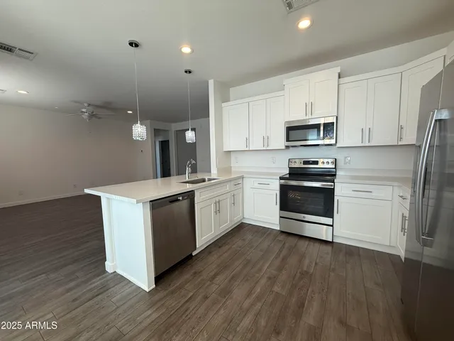 a view of a kitchen with wooden floor and a kitchen