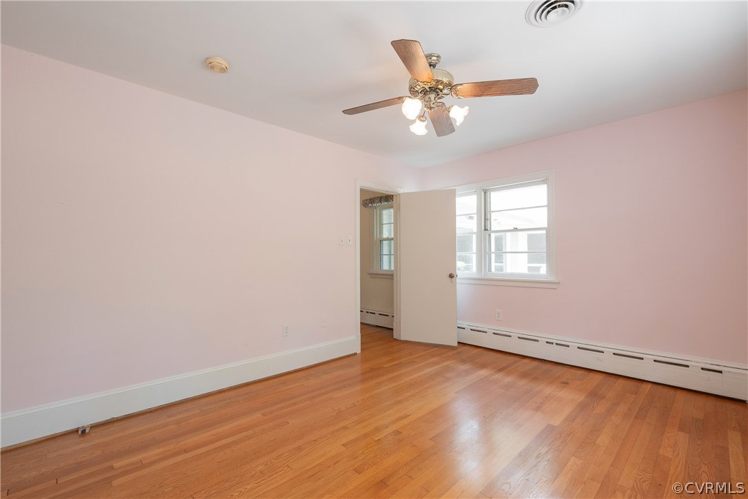 8401 Halesworth Road Richmond, VA 23235 - Photo 17 of 50 an empty room with wooden floor fan and windows