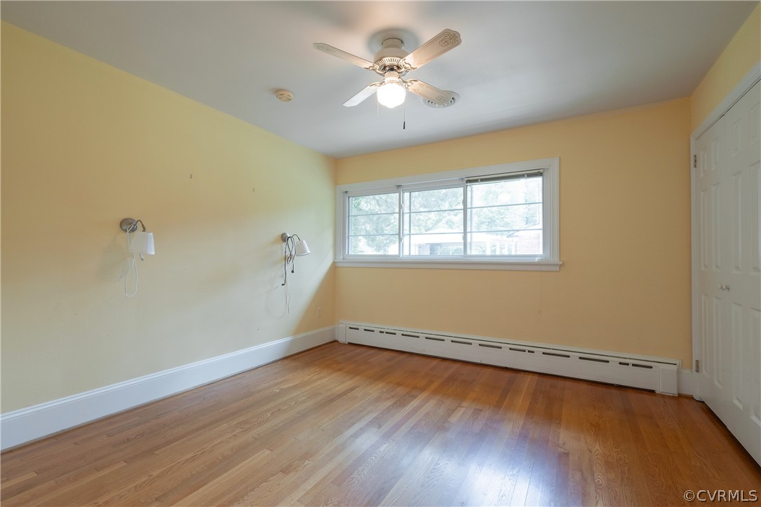 8401 Halesworth Road Richmond, VA 23235 - Photo 19 of 50 an empty room with wooden floor and windows