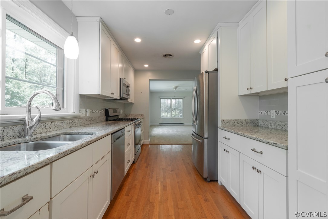 8401 Halesworth Road Richmond, VA 23235 - Photo 22 of 50 a kitchen with granite countertop a sink stove refrigerator and cabinets