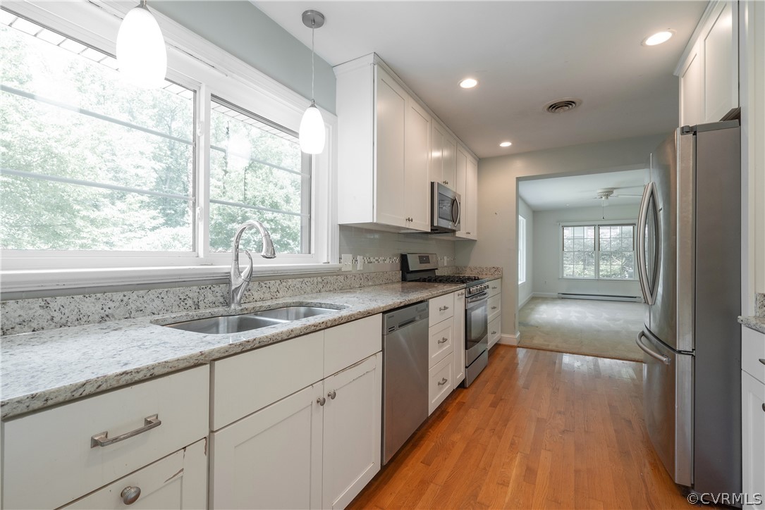 8401 Halesworth Road Richmond, VA 23235 - Photo 23 of 50 a kitchen with granite countertop stainless steel appliances a sink window and cabinets