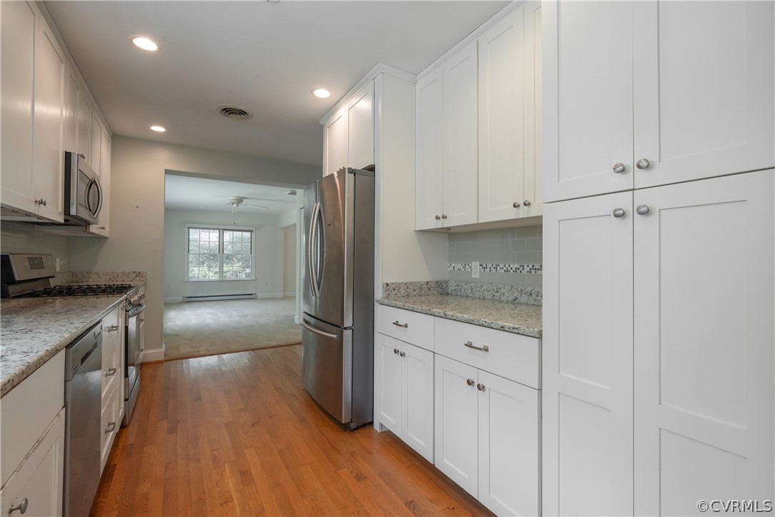 8401 Halesworth Road Richmond, VA 23235 - Photo 24 of 50 a kitchen with granite countertop white cabinets and stainless steel appliances