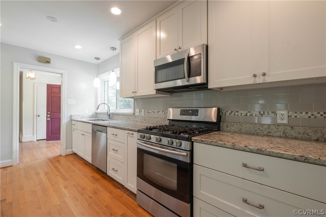 8401 Halesworth Road Richmond, VA 23235 - Photo 27 of 50 a kitchen with stainless steel appliances granite countertop wooden cabinets granite counter tops and a hard wood floors