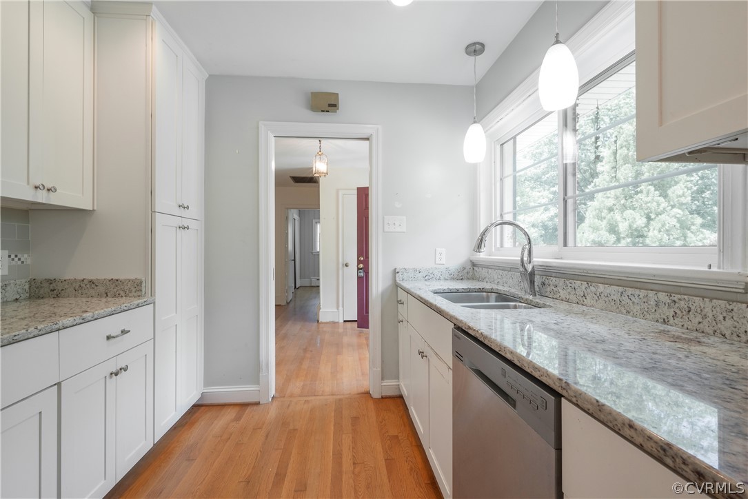 8401 Halesworth Road Richmond, VA 23235 - Photo 28 of 50 a kitchen with granite countertop a sink and cabinets with wooden floor