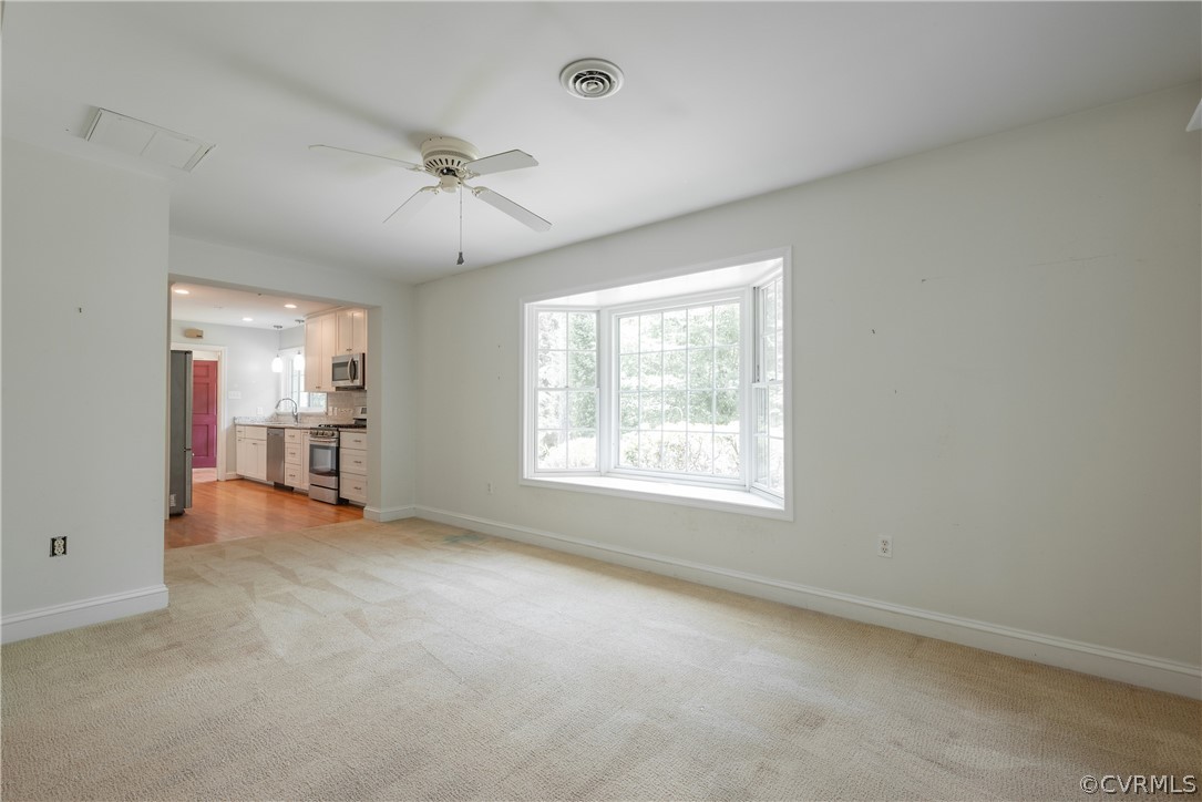 8401 Halesworth Road Richmond, VA 23235 - Photo 31 of 50 a view of a livingroom with a window and a ceiling fan