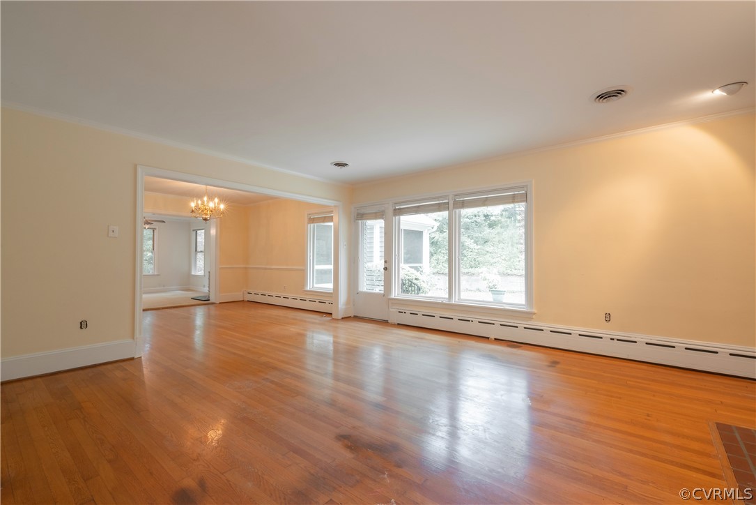 8401 Halesworth Road Richmond, VA 23235 - Photo 40 of 50 a view of an empty room with wooden floor and a window