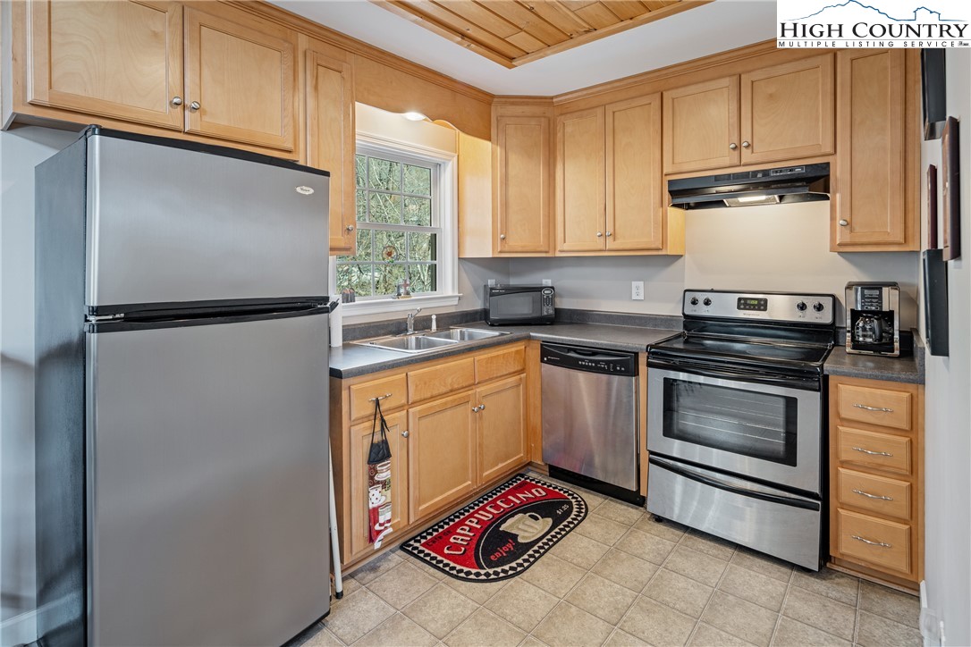 130 Alexander Drive Boone, NC 28607 - Photo 9 of 48 a kitchen with stainless steel appliances granite countertop a refrigerator sink and stove