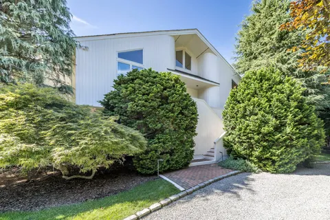 a bathroom with a tub shower and sink