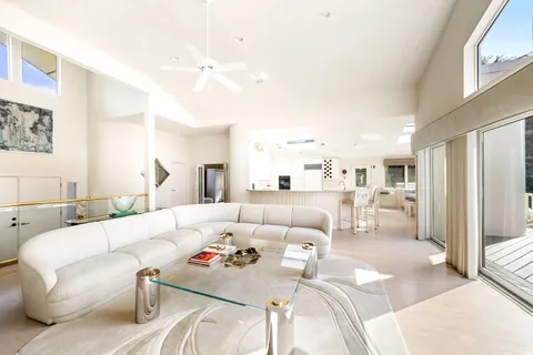 a kitchen with stainless steel appliances kitchen island granite countertop a sink and white cabinets