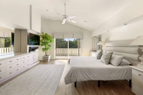 a spacious bathroom with a tub sink and mirror