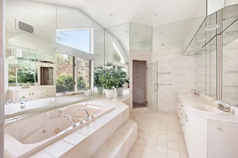 a bedroom with a large bed couch and window