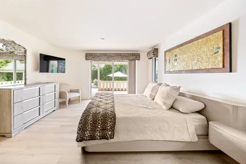 a living room with furniture and large windows