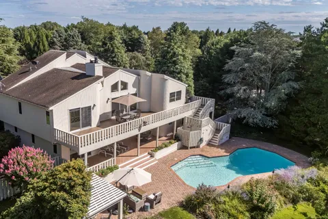 an aerial view of a house with a yard