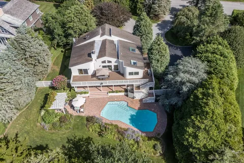 an aerial view of a house with swimming pool and garden view
