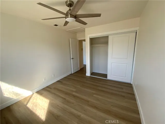a view of an empty room and wooden floor