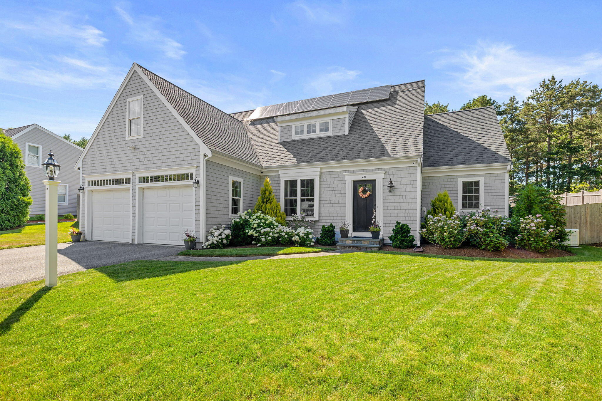 48 Meadowbrook Road Mashpee, MA 02649 - Photo 1 of 52 a front view of a house with swimming pool