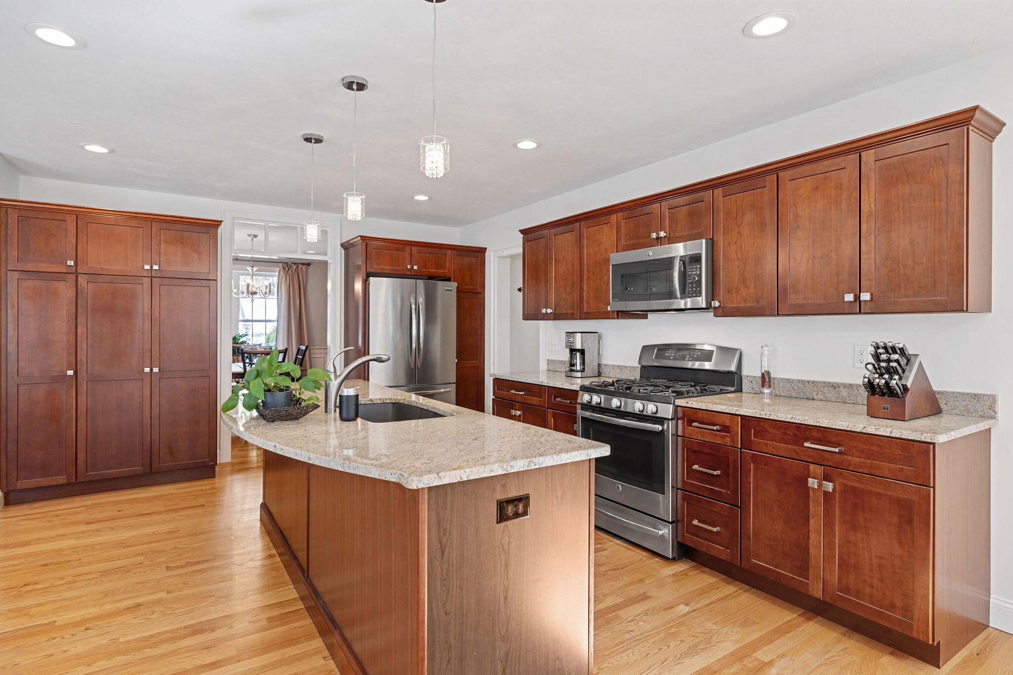48 Meadowbrook Road Mashpee, MA 02649 - Photo 15 of 52 a kitchen with stainless steel appliances granite countertop a stove top oven a sink dishwasher and a refrigerator with wooden floor