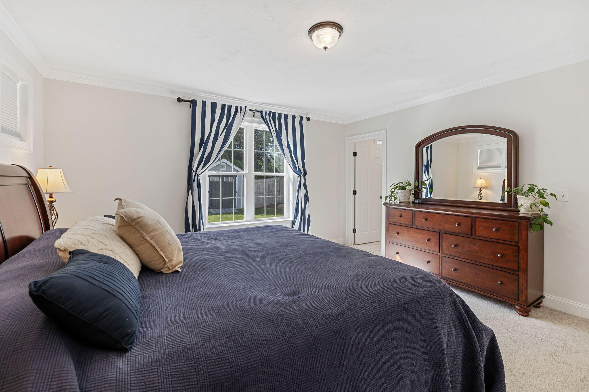 48 Meadowbrook Road Mashpee, MA 02649 - Photo 23 of 52 a bedroom with a bed and a dresser